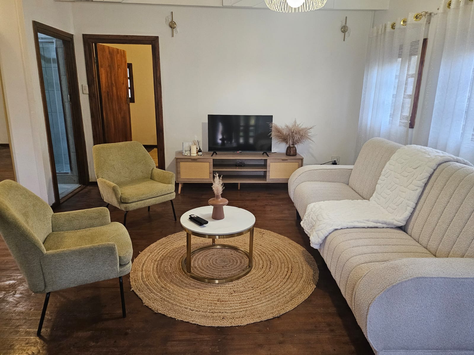 Bridal suite lounge with a TV, armchairs and sofa for relaxing before the ceremony